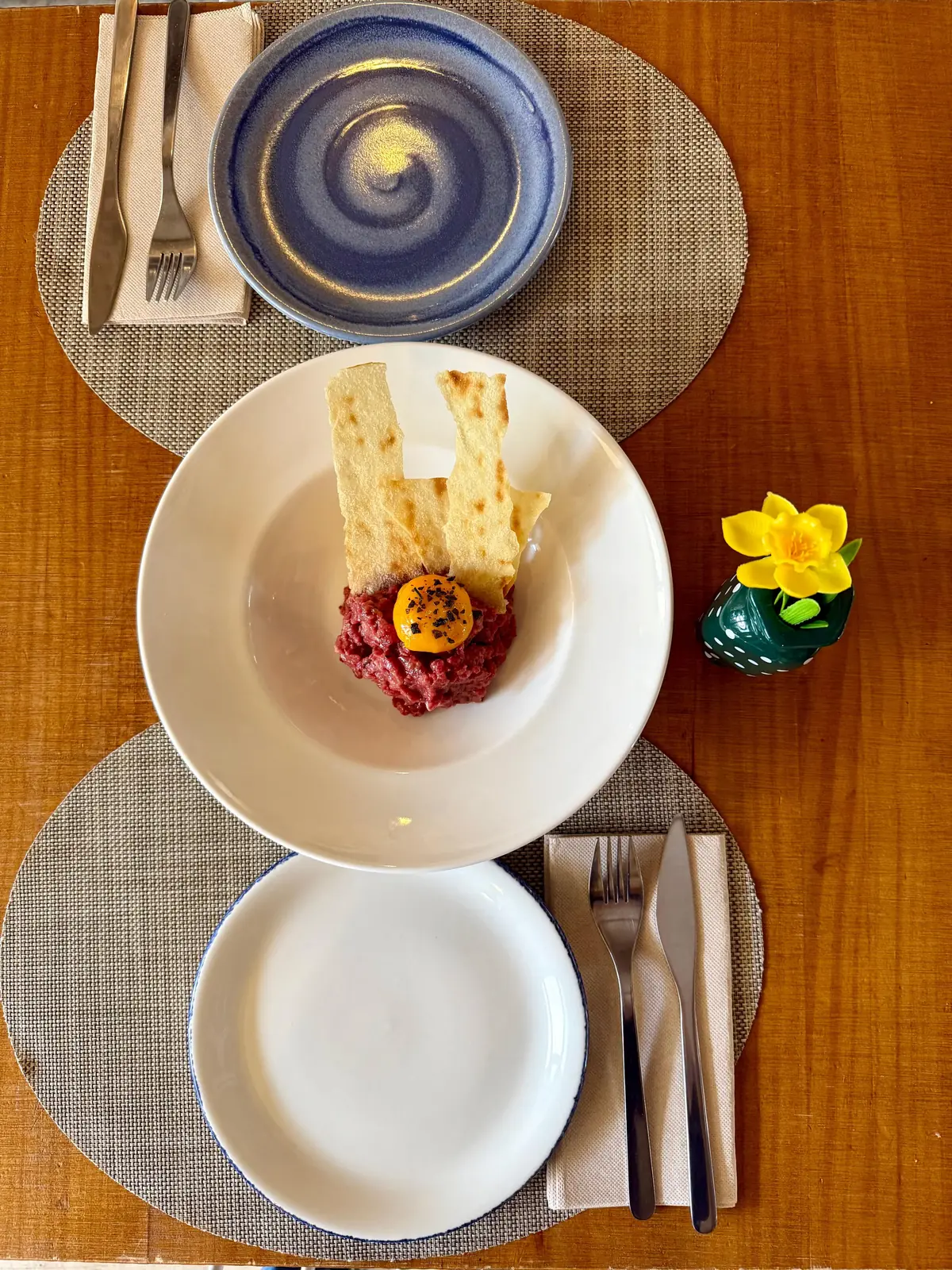 Beef tartare with flowers on the table